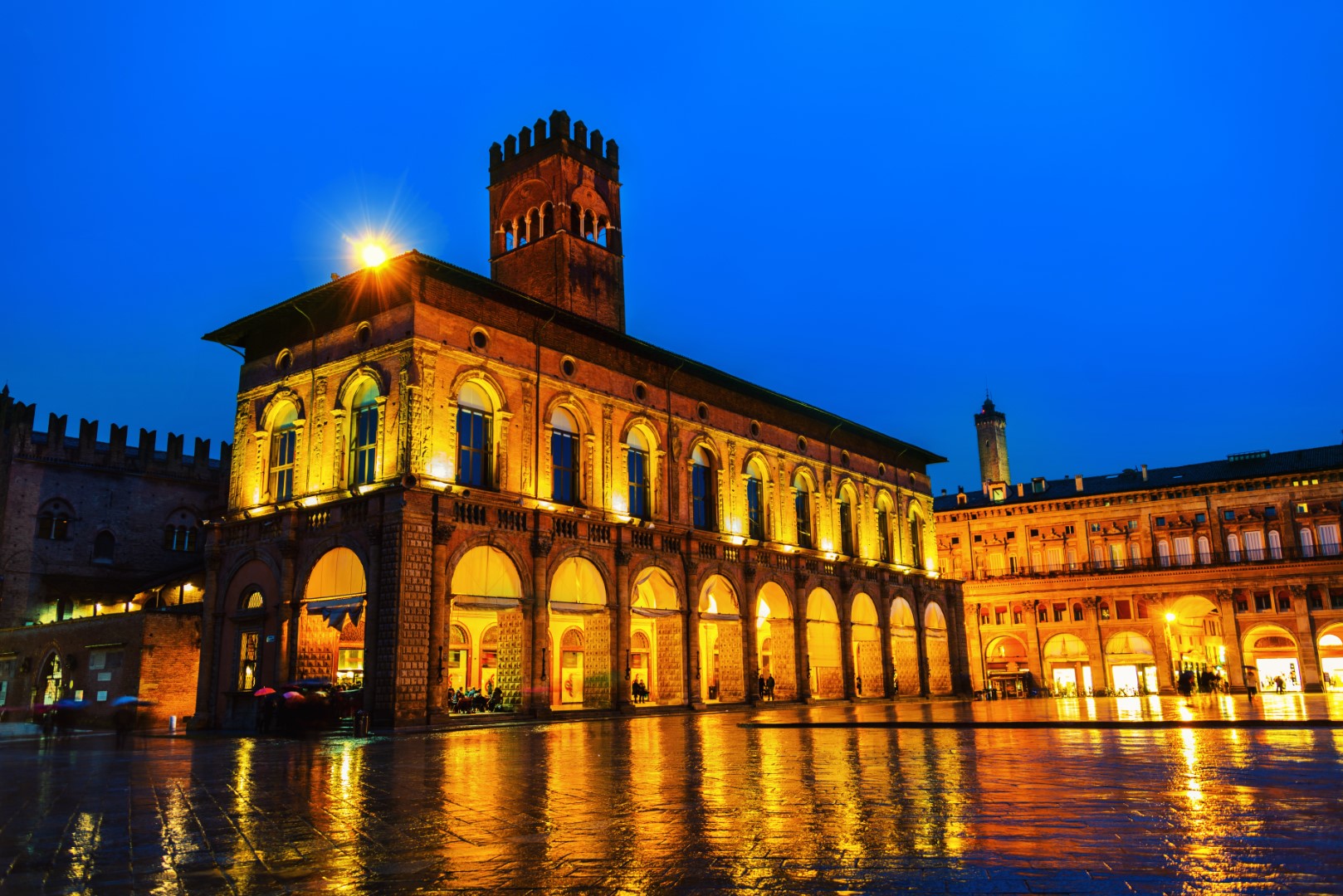 Bologna, Italy. King Enzo palace at the main square of Bologna, Italy. Famous landmark at sunset at night.