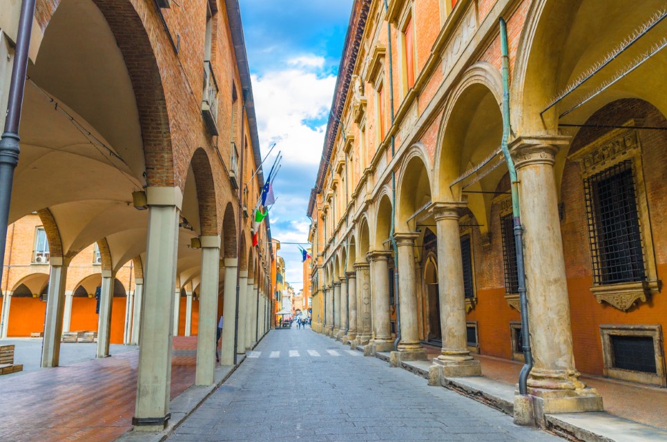 Typical italian street, buildings with columns, Palazzo Poggi museum, Since Academy and university in old historical city centre of Bologna, Emilia-Romagna, Italy