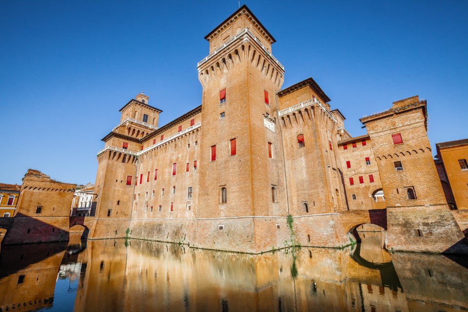 The Castello Estense in Ferrara in Italy. Moated medieval castle in the center of Ferrara, northern Italy. It consists of a large block with four corner towers.